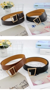Close-up of trapezoidal gold buckles on vintage leather belts in black and brown colors
