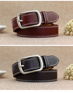 Detail of retro leather belts with double white stitching and silver matte buckles