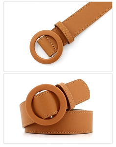 Detail of camel leather belt featuring a large round wrapped buckle and fine stitching