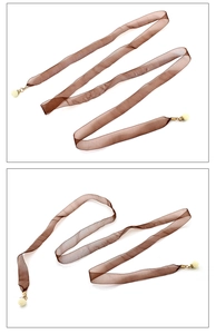 Vue détaillée de la ceinture en mousseline marron avec pendentif perle et attaches dorées chic