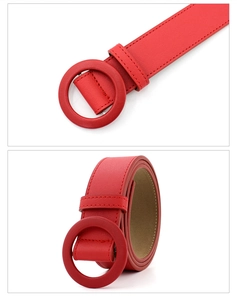 Detailed close-up of red leather belt with round matching buckle and fine stitching