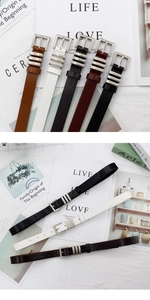 Detail showing slim leather belts in various colors with silver buckles and rings