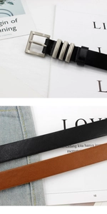 Detail of black and brown leather belts with silver square buckles and metal rings