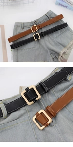 Detail of square gold metal buckles and fine stitching on black and tan leather belts