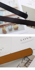 Detail of premium black and caramel brown leather belts with refined edge sealing finish