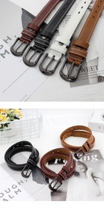 Close-up of stylish women's skinny belts with white double stitching and metal pin buckle