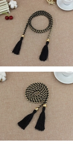 Dettaglio della corda intrecciata nero e oro con perline metalliche e nappe eleganti