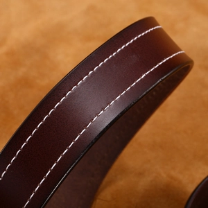 Deep brown leather belt with white double stitching and a classic square buckle