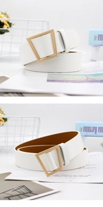 Detail of white textured leather belt with unique irregular geometric gold buckle