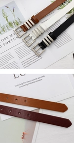 Detail of colorful women's skinny belts with matte silver buckles and metal rings