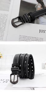 Detail of black leather belt with double white stitching and gunmetal buckle