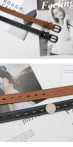 Detail of slim leather belts with white stitching and black metal buckles in brown and black