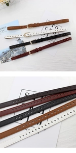 Detailed view of skinny faux leather belts with all-over holes and metal buckles in four colors