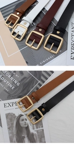 Detail of four vintage leather belts in black brown burgundy and white with gold buckles