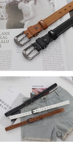 Detailed view of women's slim leather belt with contrast stitching and metal needle buckle