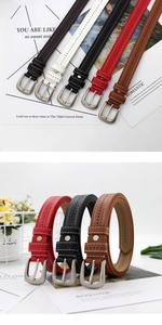 Detail of slim faux leather belts with white stitching and silver pin buckles in five colors