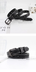 Detail of black thin leather belt with white contrast stitching and oval cutouts