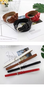 Close-up of four thin women's belts in black, brown, red, and white with silver buckles