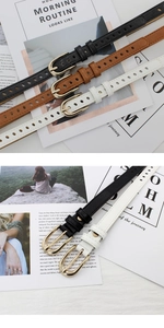 Detailed view of thin fashion belts in black, brown, and white with golden U-buckles