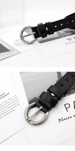 Détail de ceinture en cuir noir avec étoiles ajourées et boucle ronde argentée