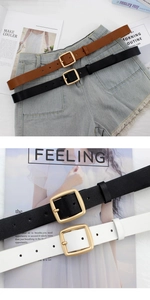 Close-up of minimalist leather belts with golden square buckles in black and brown colors