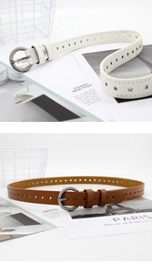 Détail de la boucle ronde argentée et des motifs en étoile perforés sur la ceinture