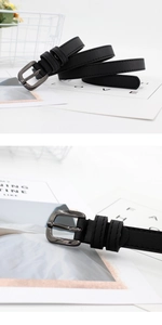 Detail of slim black leather belt featuring square gunmetal buckle and elegant texture