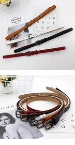 Detailed macro view of thin leather belt colors with square metal buckle on white background