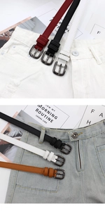 Detail showing various colors of slim leather belts paired with denim shorts on a fashion layout