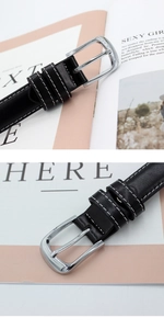 Detailed close-up of a black leather belt with contrast white stitching and silver buckle