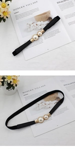 Détail de la ceinture élastique noire fine avec perles blanches et boucle dorée
