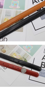 Detail of slim leather belts with white stitching and coin for size reference