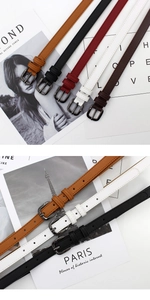 Close-up of thin leather belts with square gun-black buckles in assorted stylish colors