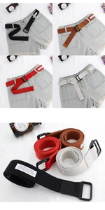 Detail of unisex canvas belts with double D-ring buckles in four colors on white fabric