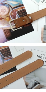 Gros plan sur ceinture en cuir marron avec boucle argentée et surpiqûres blanches