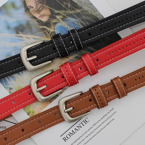 Set of three leather belts in black, red and brown with silver buckles and contrast stitching