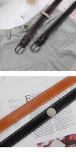 Detailed macro view of thin PU leather belts with white stitching and floral buckle detail