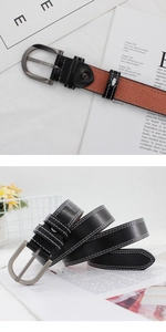 Detail of black leather belt featuring white contrast stitching and D-shape metal buckle