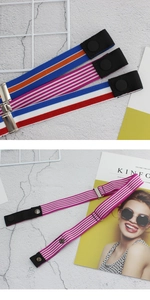 Detailed view of elastic stretch belts in three striped color patterns with adjustment buckles