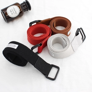 Minimalist canvas belts with double D-ring buckles in black, red, brown, and off-white