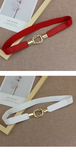 Detail of red and white elastic waist belts with golden metal interlocking buckles