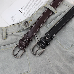Fashionable PU leather belts in black and brown with silver buckles on blue jeans