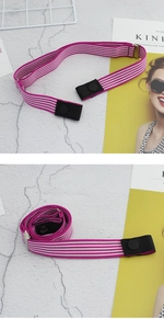 Detail of adjustable elastic belt with pink stripes and black leather button snap