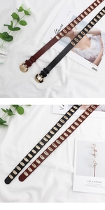 Detail view of thin faux leather belts with golden metal eyelets and horseshoe buckles