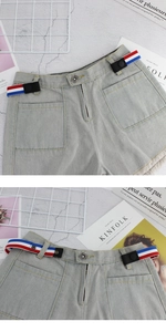 Close-up of adjustable red, white and blue elastic invisible belt on denim shorts