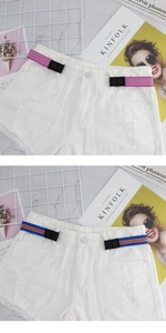 Close-up of adjustable elastic no-buckle belts on denim shorts in various striped colors