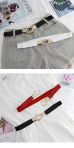 Close-up of elastic thin waist belts in black white red with gold buckle for dresses