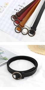 Detailed macro view of thin faux leather belts with polished gold circular metal buckles