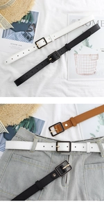 Detail of slim PU leather belts in black white and brown with a metal square buckle