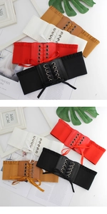Macro shot of high-elastic corset belts in black, white, red, and brown with lace-up detail